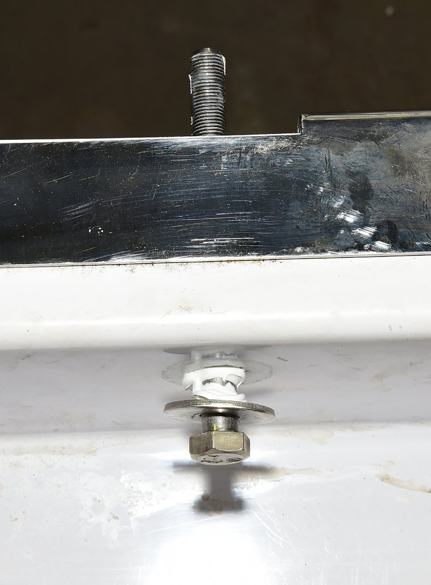 Fender washers inside the transom distribute the strain and provide plenty of surface for bedding compound.