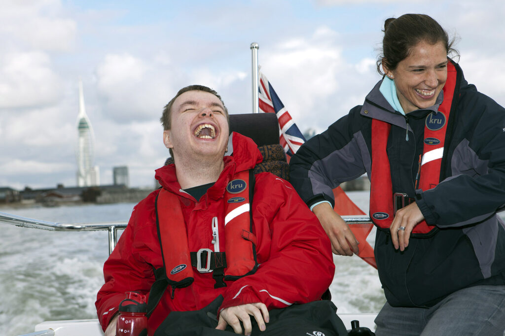 a man and woman laughing on a boat