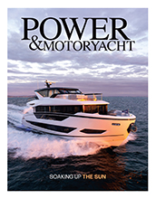Magazine cover with large white yacht on it.