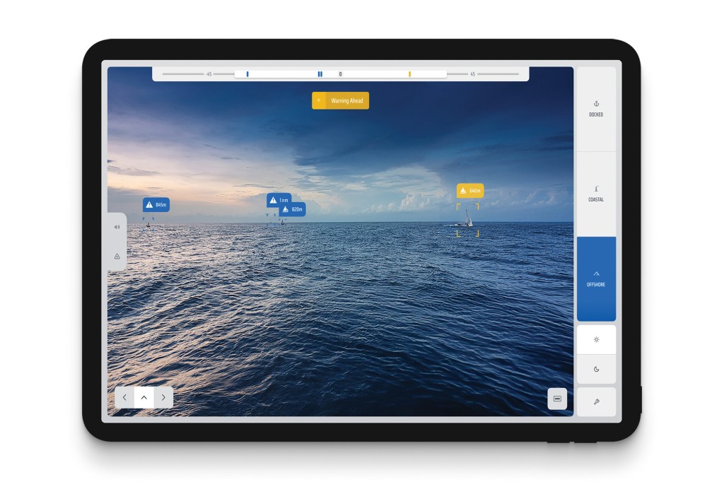 A clean studio shot of a black tablet computer displaying an AI-assisted marine navigation interface application. The screen shows a live camera view of an open blue ocean landscape under a dramatic twilight sky. The smart software automatically detects and tags multiple distant vessels on the water with digital overlay boxes, showing data tags like "640m" in yellow and "1 nm" in blue, alongside a prominent yellow "Warning Ahead" banner at the top. The right sidebar menu shows active toggle modes labeled "Docked", "Coastal", and an highlighted blue "Offshore" button.