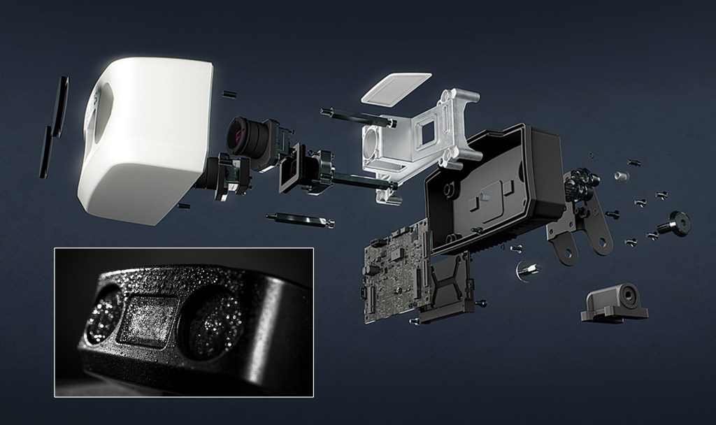 A detailed 3D exploded view diagram of a high-tech marine camera sensor unit floating against a dark slate background. The internal components are separated along a horizontal axis, revealing the outer white front casing, optical lenses, a camera assembly, a silver internal chassis frame, a green electronic circuit board (PCB), a black rear housing box, and various mounting screws and gaskets. In the bottom-left corner, a small inset photo showcases a close-up of the assembled device in a black finish, covered in water droplets to emphasize its waterproof design.