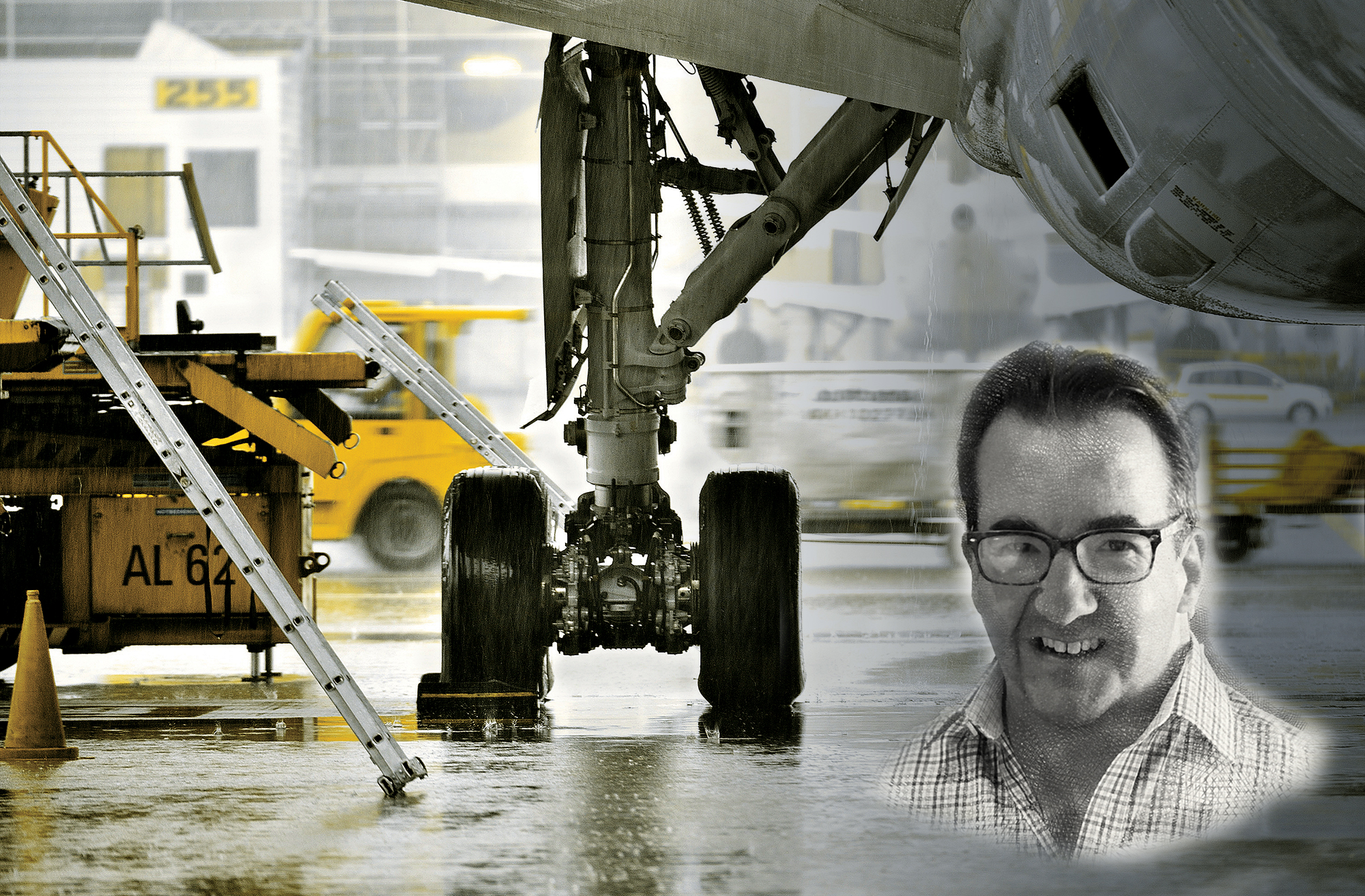 A stylized, low-angle composite image set on a wet, rainy airport tarmac, utilizing a desaturated color palette with selective yellow highlights. In the center, the heavy landing gear assembly and dual tires of a large commercial aircraft rest on the reflective ground. To the left, yellow ground support equipment, a ladder, and a traffic cone are visible. Superimposed in the lower-right corner is a black-and-white portrait of a smiling middle-aged man wearing glasses and a plaid button-down shirt.
