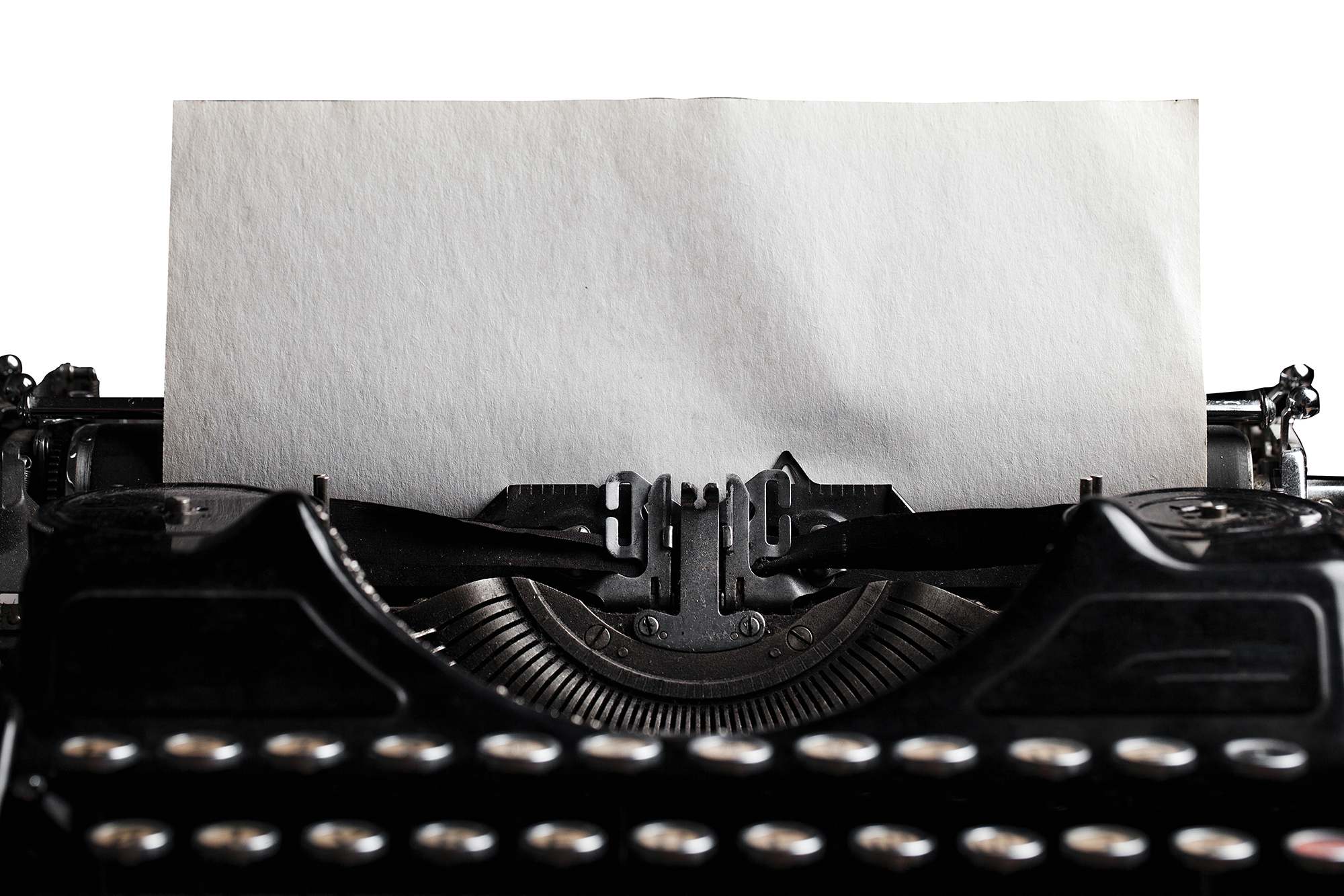 old-fashioned typewriter with a blank paper sheet.