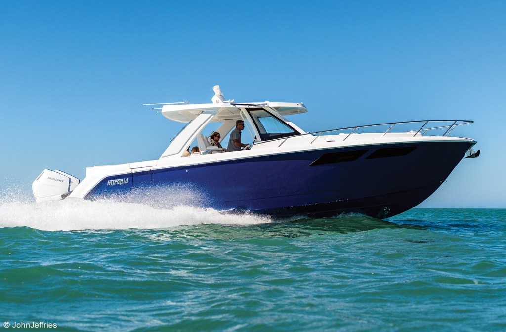feat_Intrepid 35 Valor An Intrepid 35 Valor powerboat with a deep-blue hull cruising at high speed on open blue ocean water.