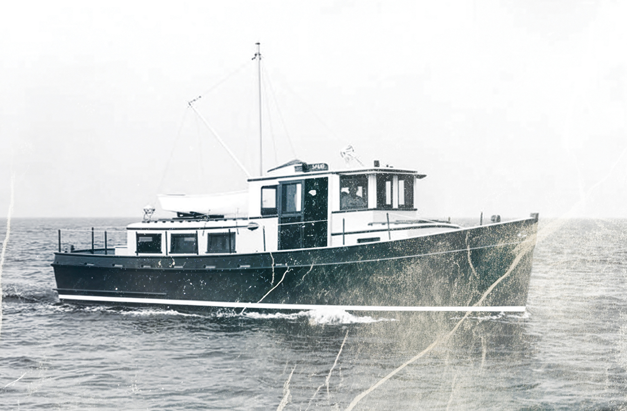 A black-and-white archival photograph showing Spray, the wooden prototype 36-foot trawler built by American Marine, underway on open water.