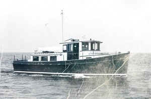 A black-and-white archival photograph showing Spray, the wooden prototype 36-foot trawler built by American Marine, underway on open water.