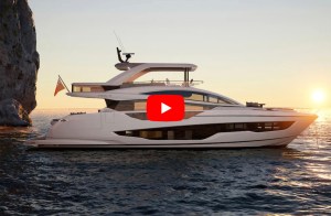 feat Pearl 73 Profile view of a Pearl 73 luxury flybridge motor yacht anchored near coastal cliffs at sunset with a video play icon overlaid.