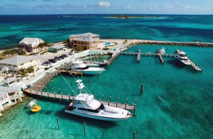 Aerial photograph of boats docked at the Bimini Big Game Club Resort & Marina in bright turquoise ocean water.