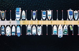 Aerial view of boats, yachts, water bike and wooden sauna in a marina in summer Finland