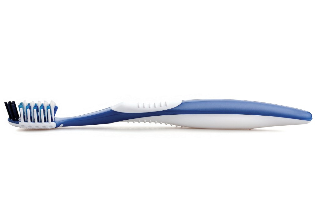 A side-profile studio photo of a blue and white manual toothbrush isolated on a plain white background.