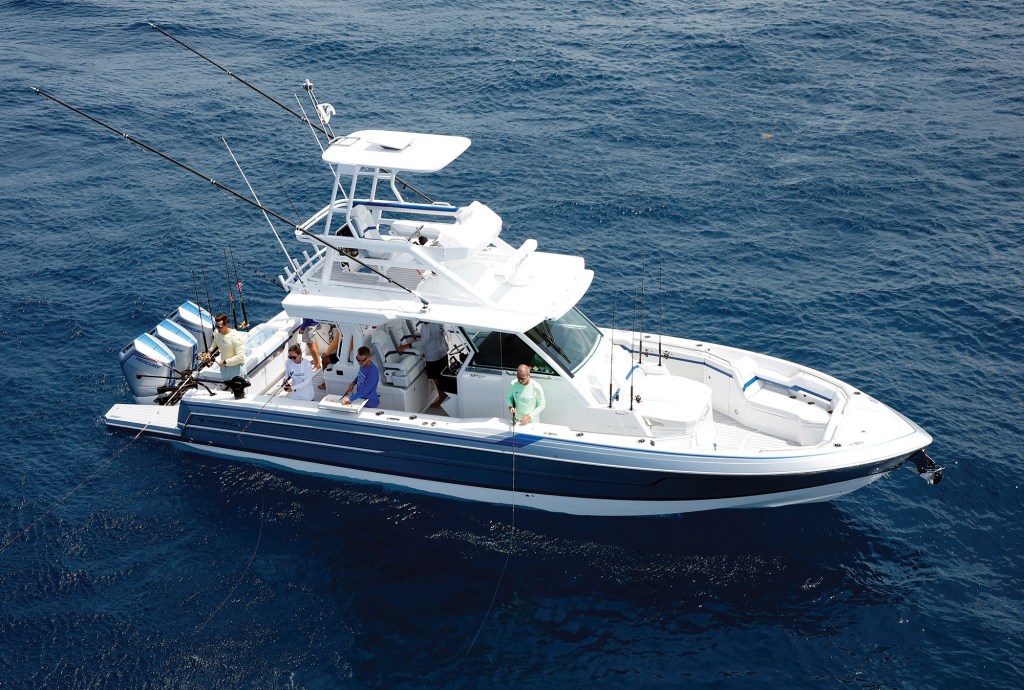 Aerial view of a Formula 387 Center Console Fish boat stationary in deep blue water with anglers fishing from the cockpit and bow.