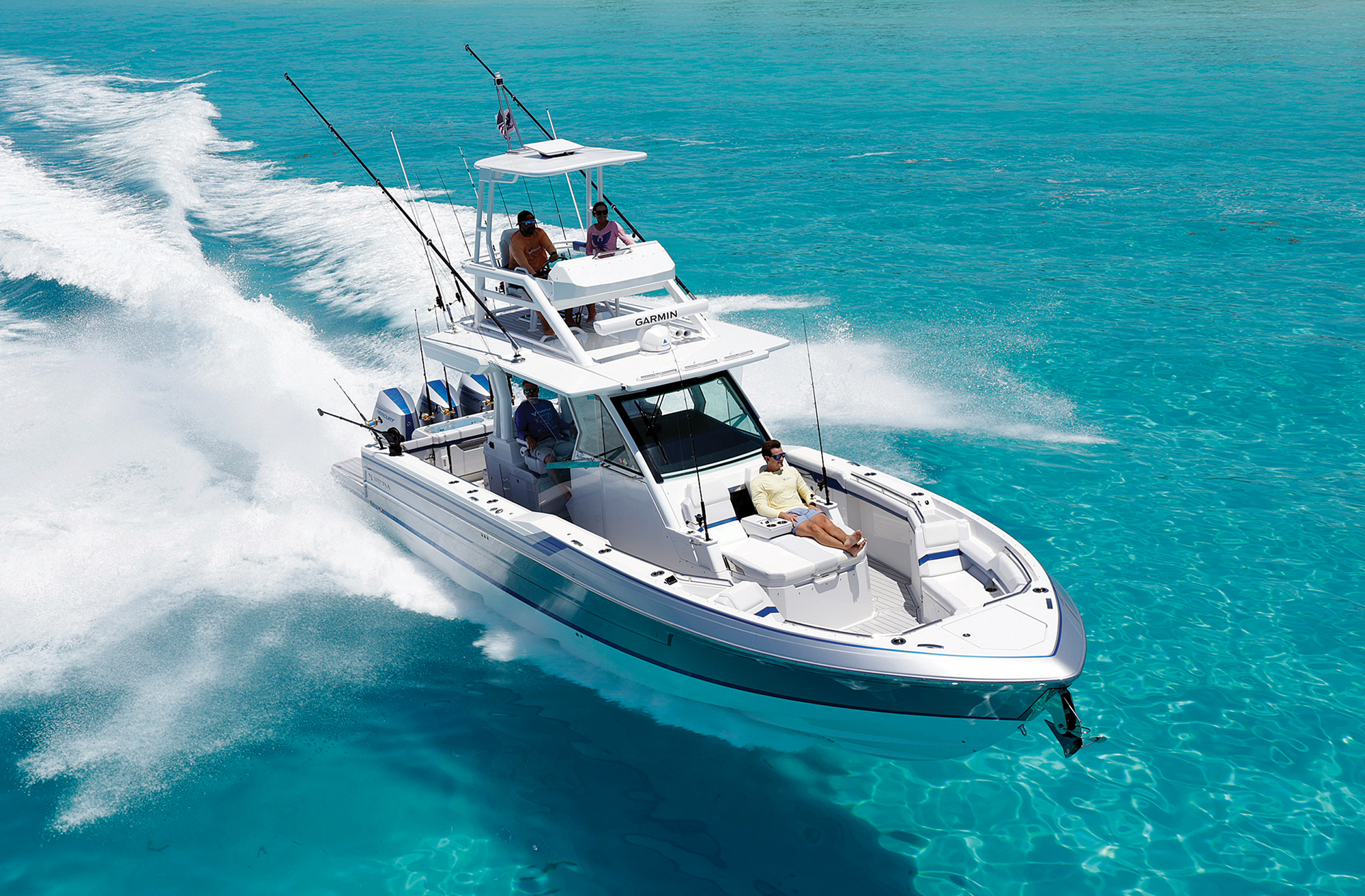 A Formula 387 Center Console Fish boat with a upper tower station cruising through turquoise waters under full power.