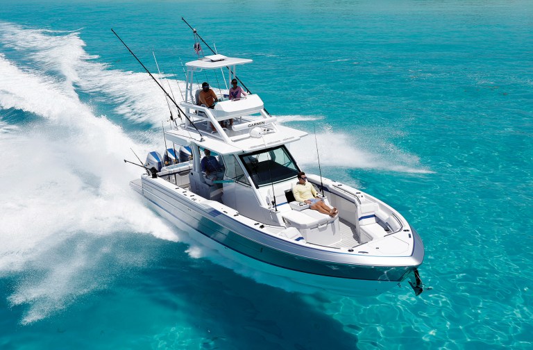 feat_Formula 387 CCF A Formula 387 Center Console Fish boat with a upper tower station cruising through turquoise waters under full power.